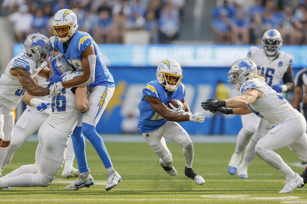 Chargers wide receiver Derius Davis runs with the ball against the Detroit Lions last month.