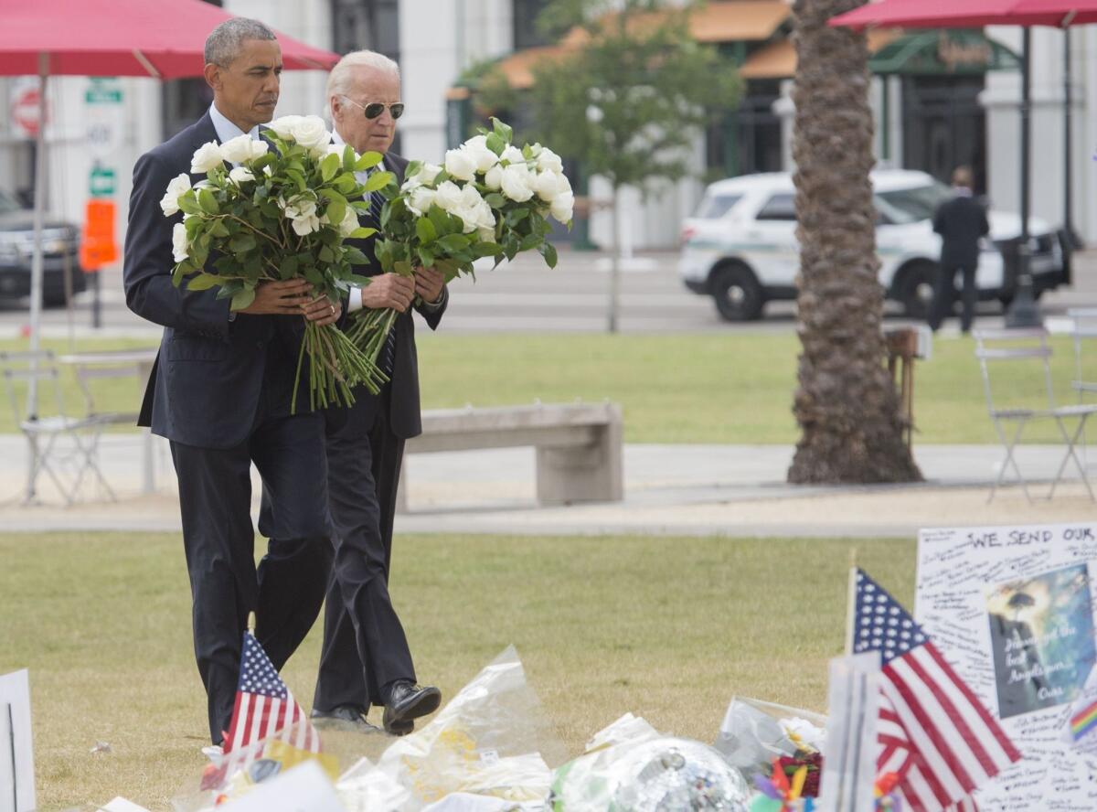 President Obama and Vice President Joe Biden place flowers for the shooting victims at a memorial at the Dr. Phillips Center for the Performing Arts in Orlando, Fla., on June 16, 2016.