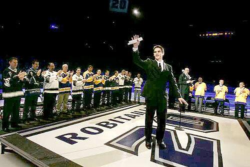 Kings officially retired Luc Robitaille's jersey No. 20 during a pregame ceremony Saturday at Staples Center. He is the highest scoring left wing in NHL history and the Kings' franchise leader in goals scored. Robitaille waves to fans as he is surrounded by former Kings players and coaches.