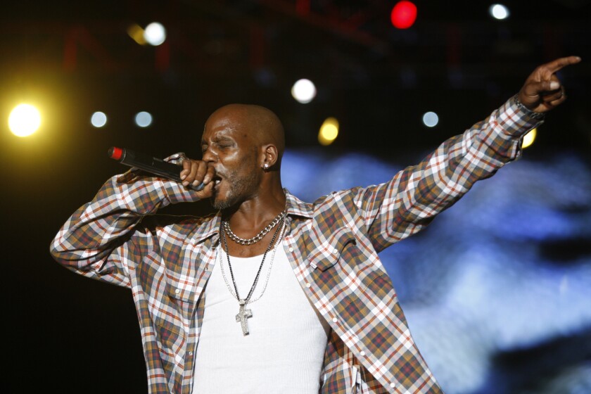 Rapper DMX performs with a microphone onstage
