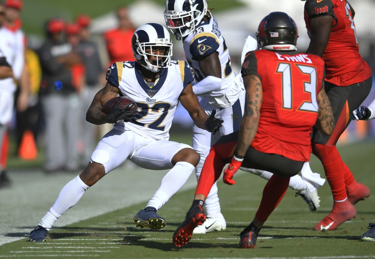 The Rams' Marcus Peters returns an interception for a touchdown against the Buccaneers.