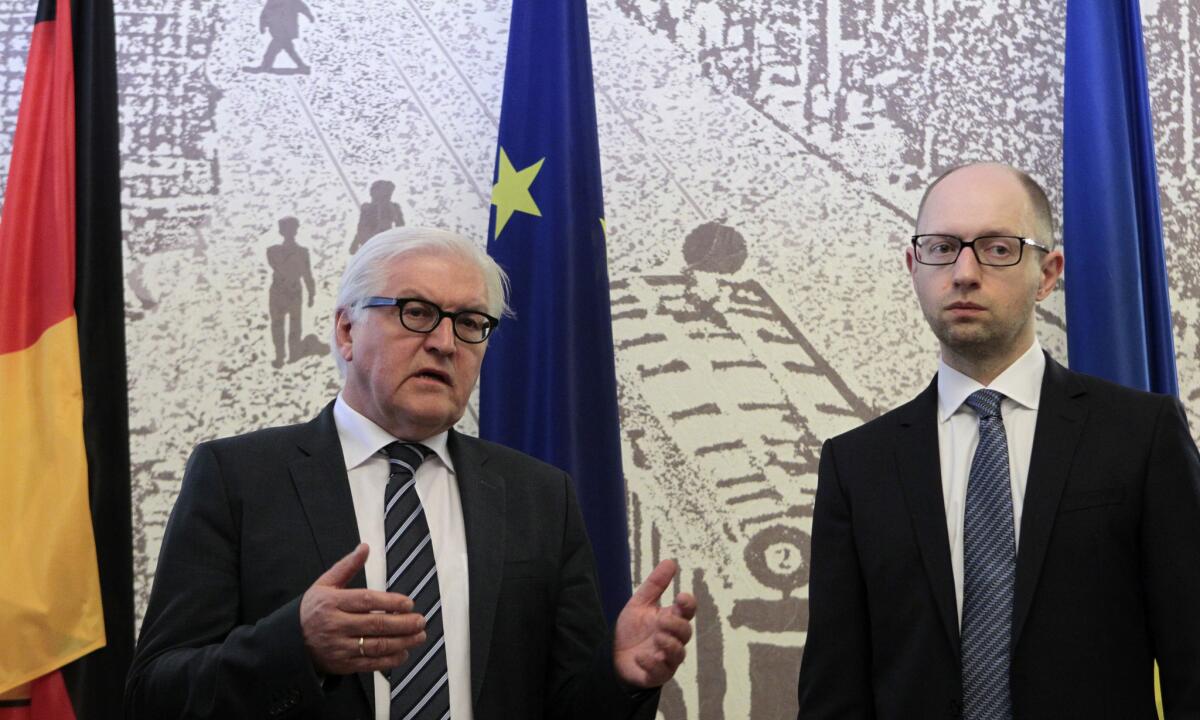 German Foreign Minister Frank-Walter Steinmeier, left, and Ukrainian Prime Minister Arseny Yatsenyuk on Tuesday warned pro-Russia separatists in eastern Ukraine against attempts to disrupt the country's presidential election on May 25.