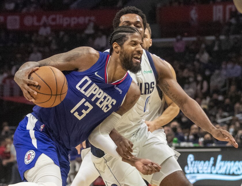 Clippers guard Paul George drives on Dallas Mavericks forward Sterling Brown/.