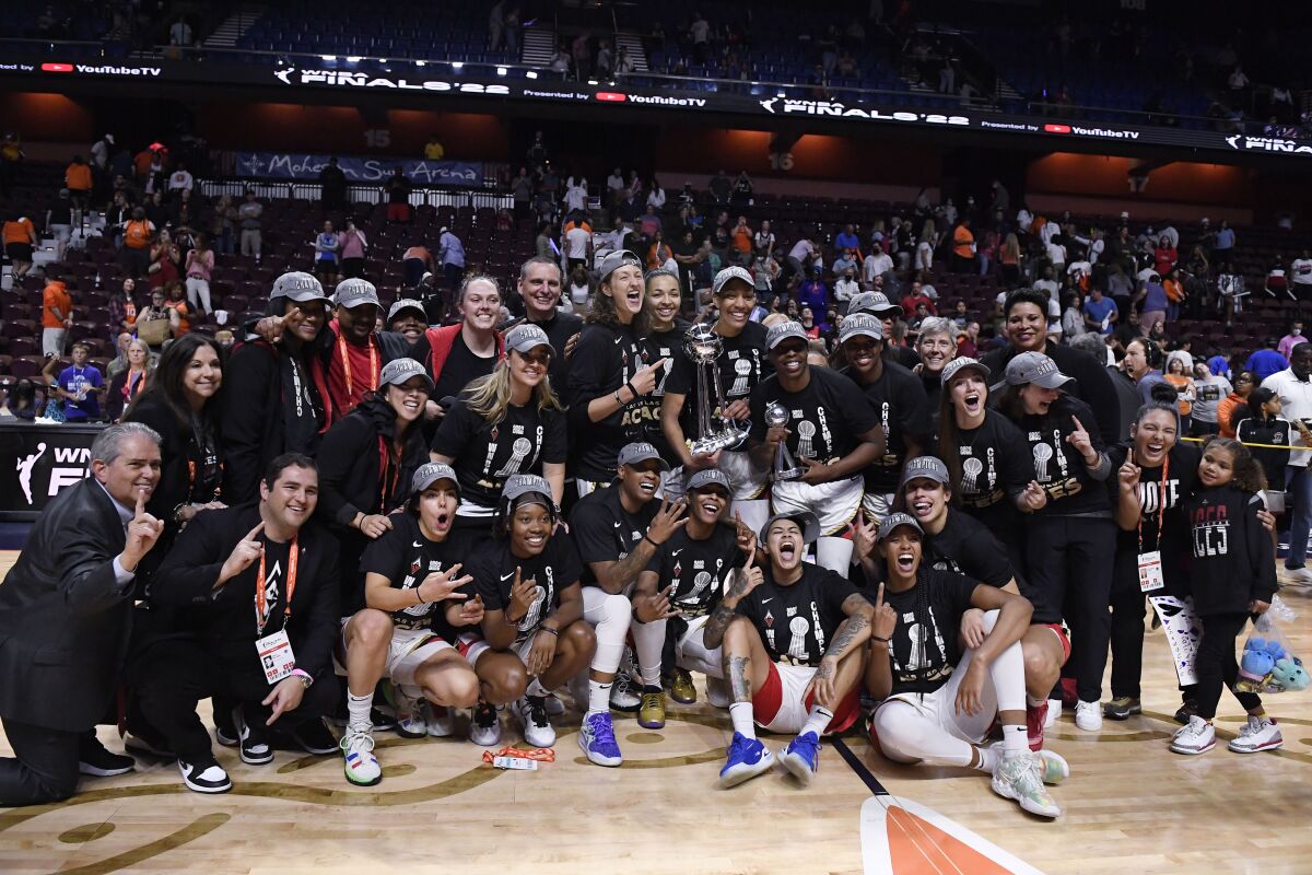 The Las Vegas Aces pose for a team photo after winning the WNBA title Sunday.