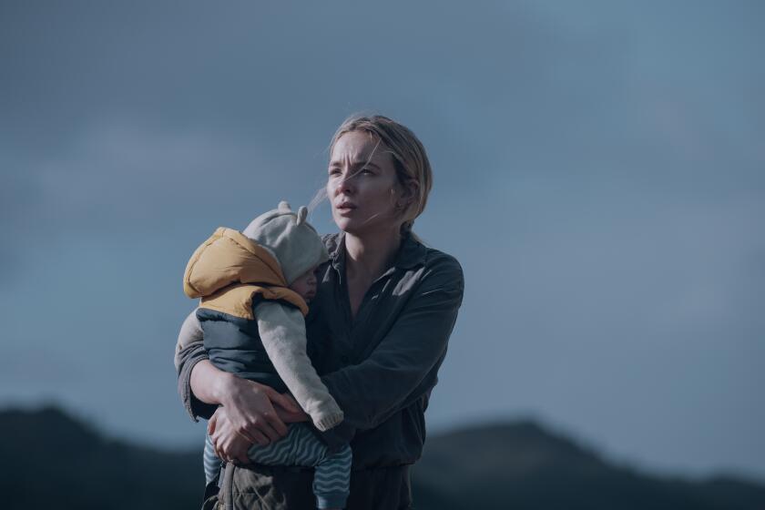 A woman holds a baby during an emergency.