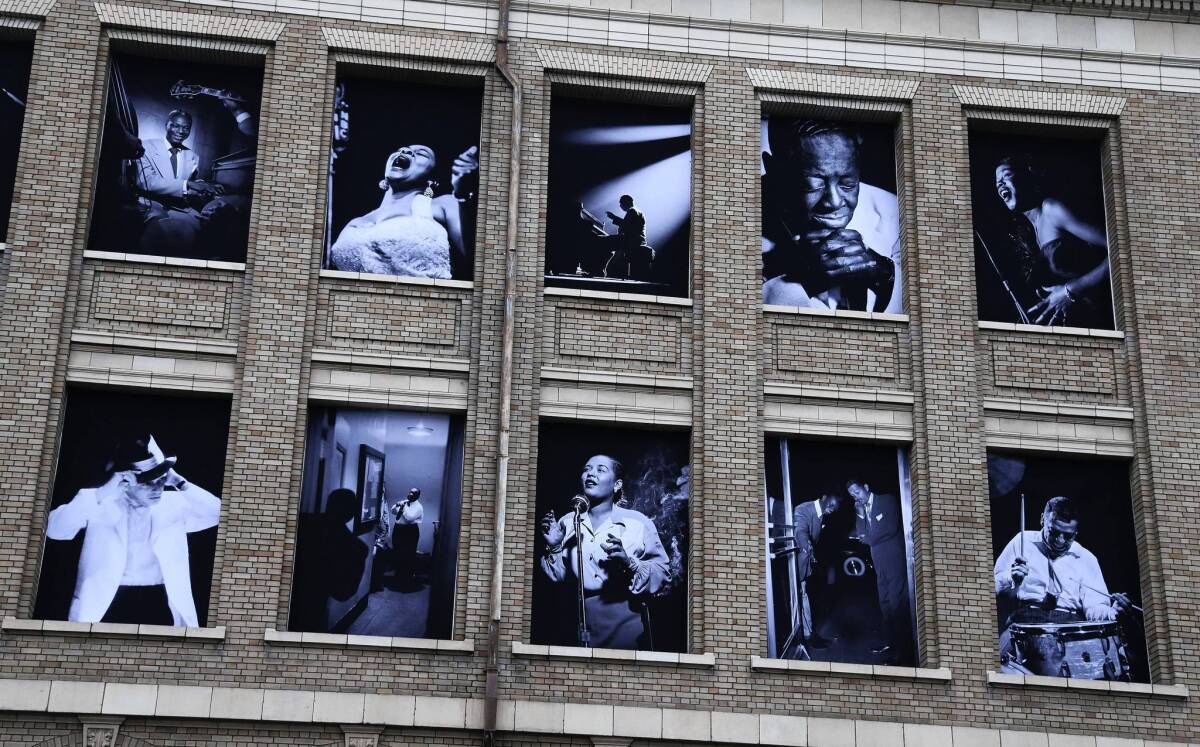 Large jazz photographs by Herman Leonard are displayed on a building across the street from the opening night concert of the SFJAZZ Center in San Francisco.