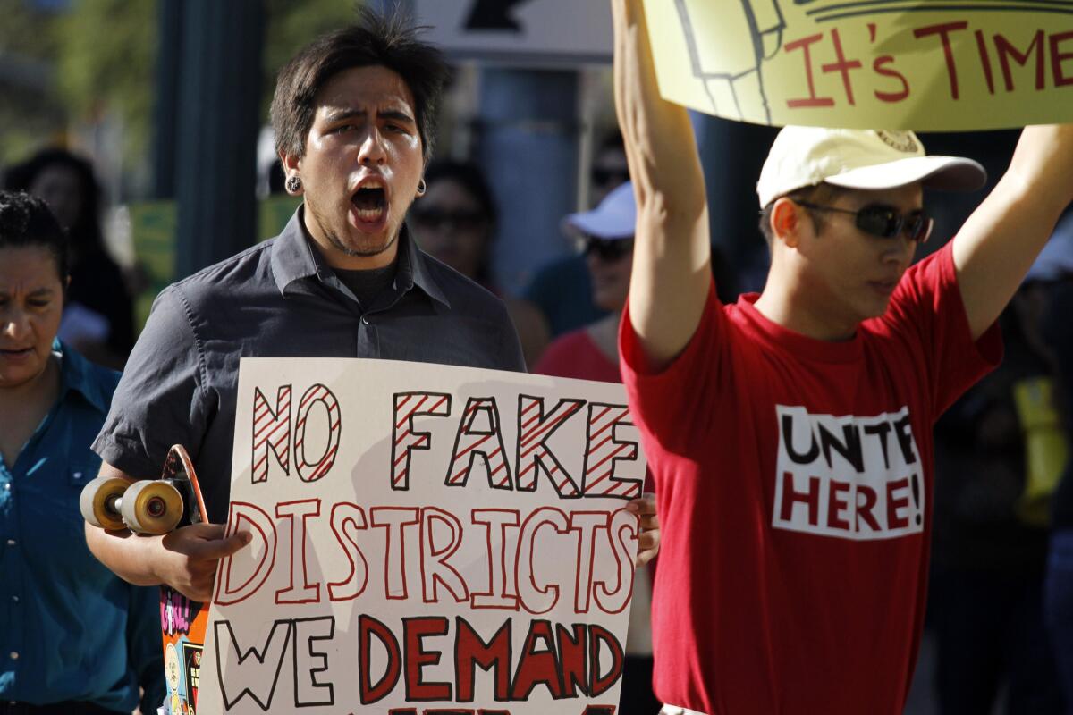 Anaheim resident Jesse Murillo, left, was among those who protested the Anaheim City Council's election plan, which they felt did not address their concerns.