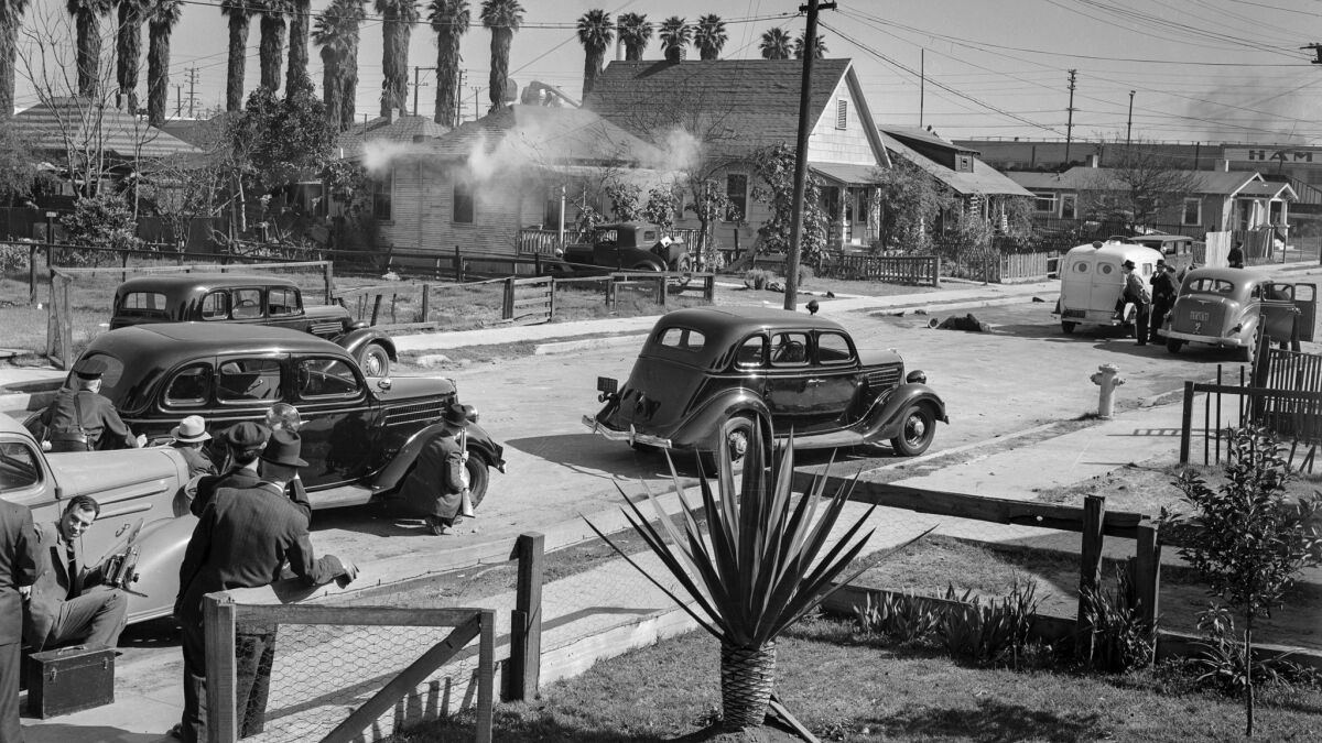 Feb. 17, 1938: Tear gas issues from a home in the 1700 block of East 22nd Street as police trade shots with barricaded suspect George Farley.