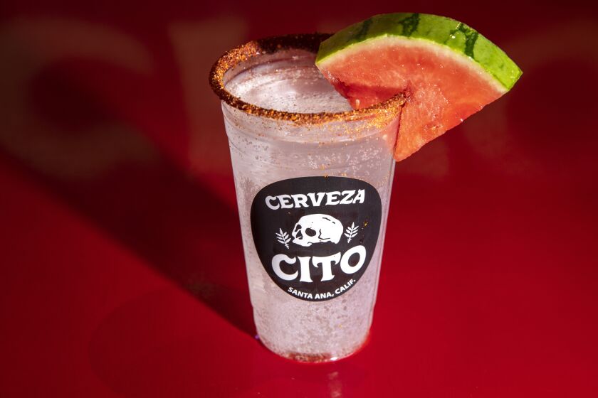 Sandia seltzer, a watermelon seltzer, with a wedge of watermelon, at Cerveza Cito in Santa Ana