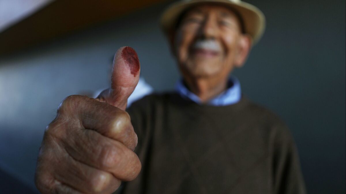 A voter displays proof that he voted in Tijuana in Mexico's presidential election on July 1, 2018.