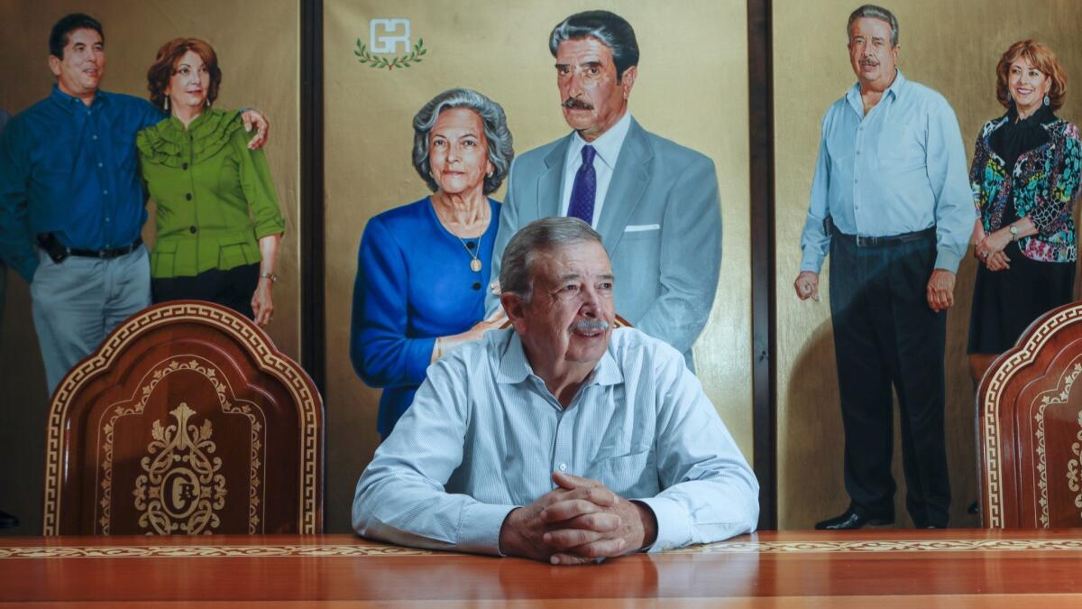Miguel Gonzalez Reynoso, co-president of the Northgate Gonzalez supermarkets, sits before a mural of his parents. He was the third-oldest child of matriarch Teresa Reynoso de Gonzalez.