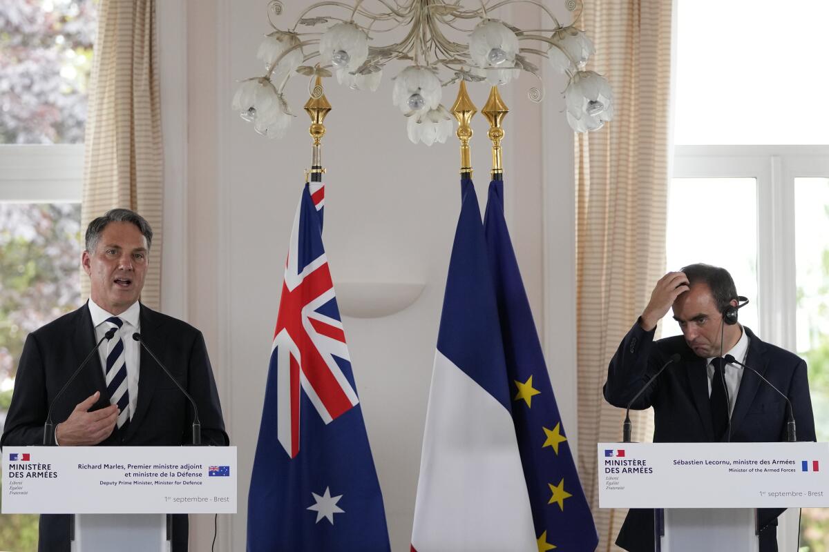 Deputy Prime Minister of Australia and Minister for Defense Richard Marles, left, speaks during a joint press conference with French Defense Minister Sebastien Lecornu Thursday, Sept. 1, 2022 in Brest, Brittany. After coming to power in May elections, Australian Prime Minister Anthony Albanese's Labor Party government announced it had agreed to pay France's Naval Group a 555-million-euro ($583 million) settlement for breaking the contract for French-made diesel-electric submarines. (AP Photo/Francois Mori)