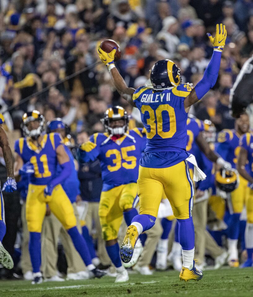 Rams running back Todd Gurley celebrates along with his teammates on the sideline after his TD run in the second quarter.