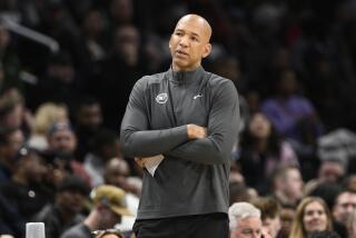 Detroit Pistons coach Monty Williams crosses his arms and looks on from the sideline during a game. 