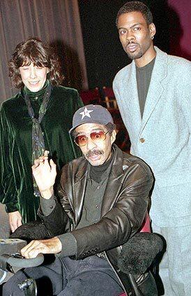 Lilly Tomlin and Chris Rock greet Richard Pryor at a special tribute to Pryor at the Directors Guild of America in Los Angeles on November 10, 1995.