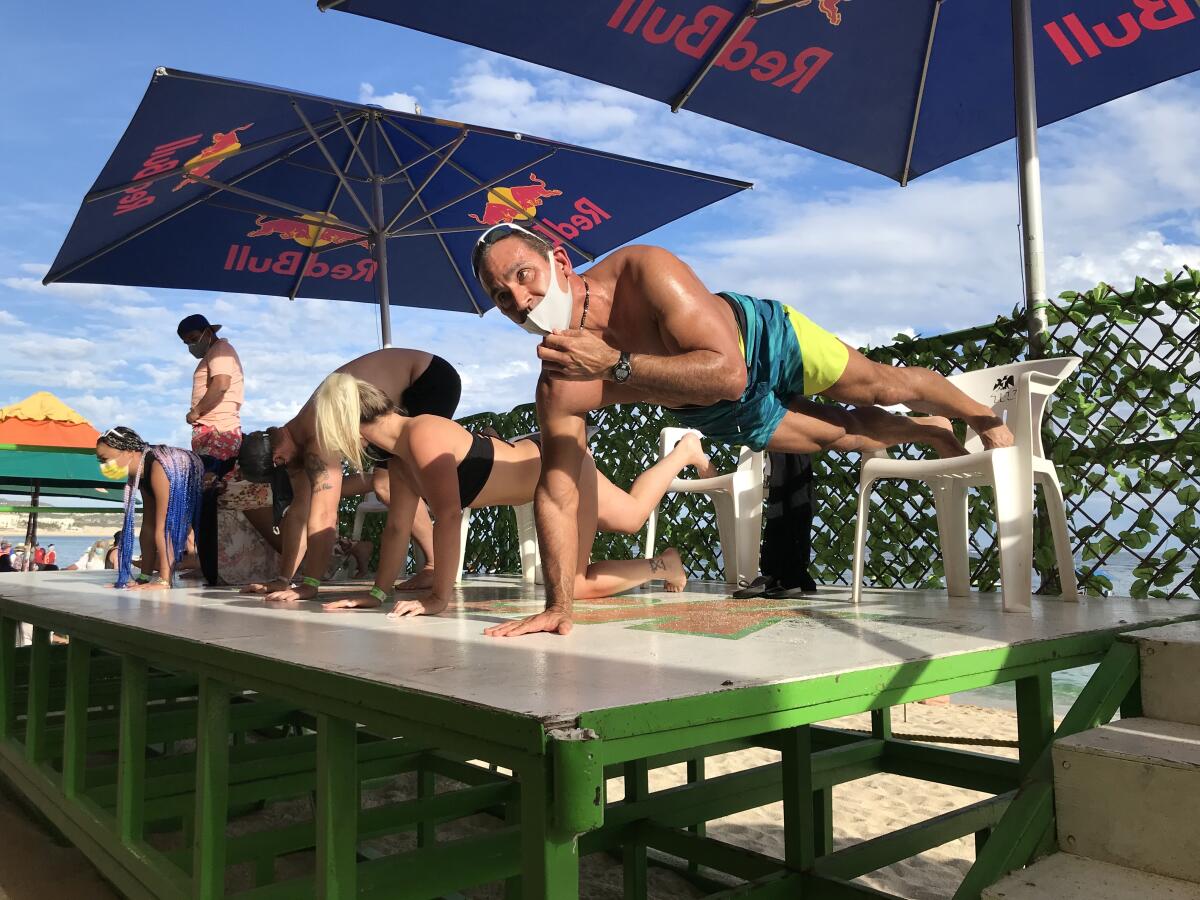 A push-up competition at Mango Deck, a beach bar in Cabo San Lucas.