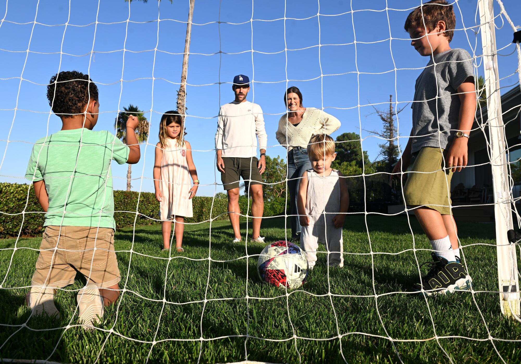 LAFC defender Ryan Hollingshead and his wife, Taylor, play soccer with their children