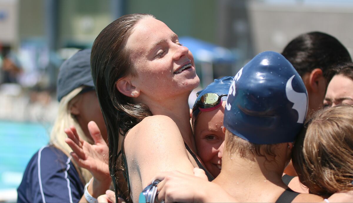 Harvey celebrating with teammates following her CIF 100 backstroke victory.