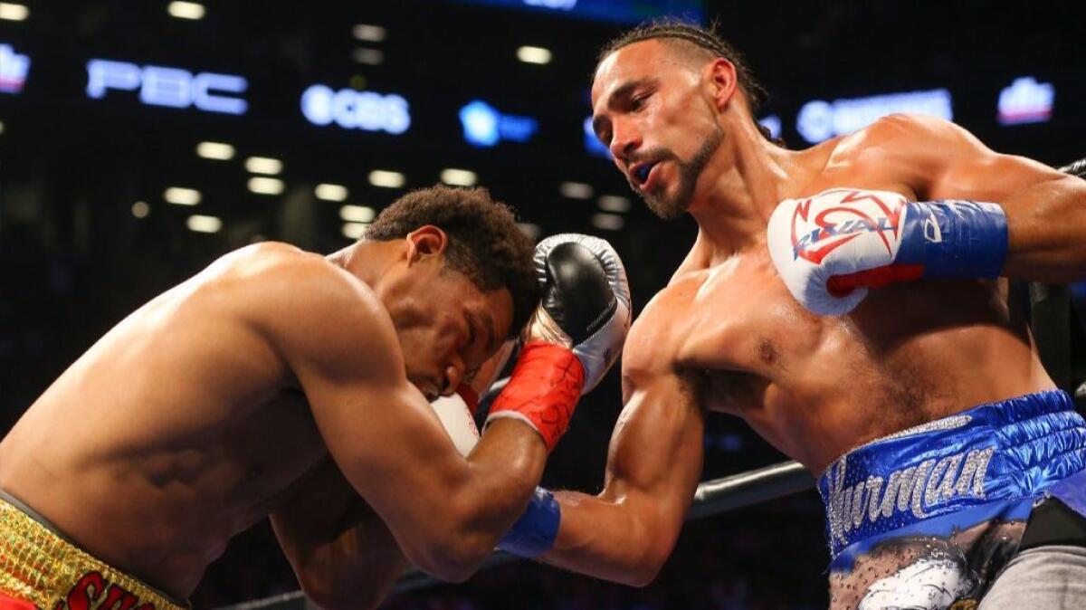 Keith Thurman, right, lands an uppercut against Shawn Porter during their World Boxing Assn. welterweight championship bout on June 25, 2016.