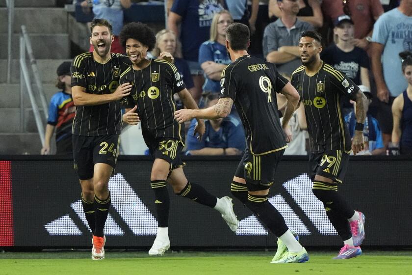 Los Angeles FC attacker David Martínez (30) celebrates with teammates after scoring a goal.