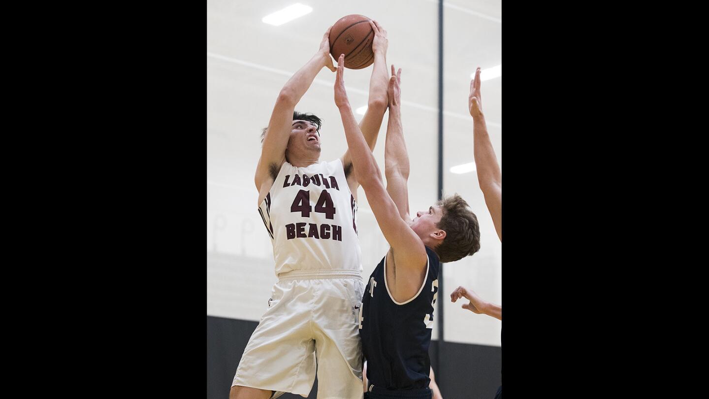 Laguna Beach's Blake Burzell goes up for a shot against Newport Harbor's Dayne Chalmers in the semifinals of the Grizzly Invitational at Godinez Highshcool on Friday, December 1.