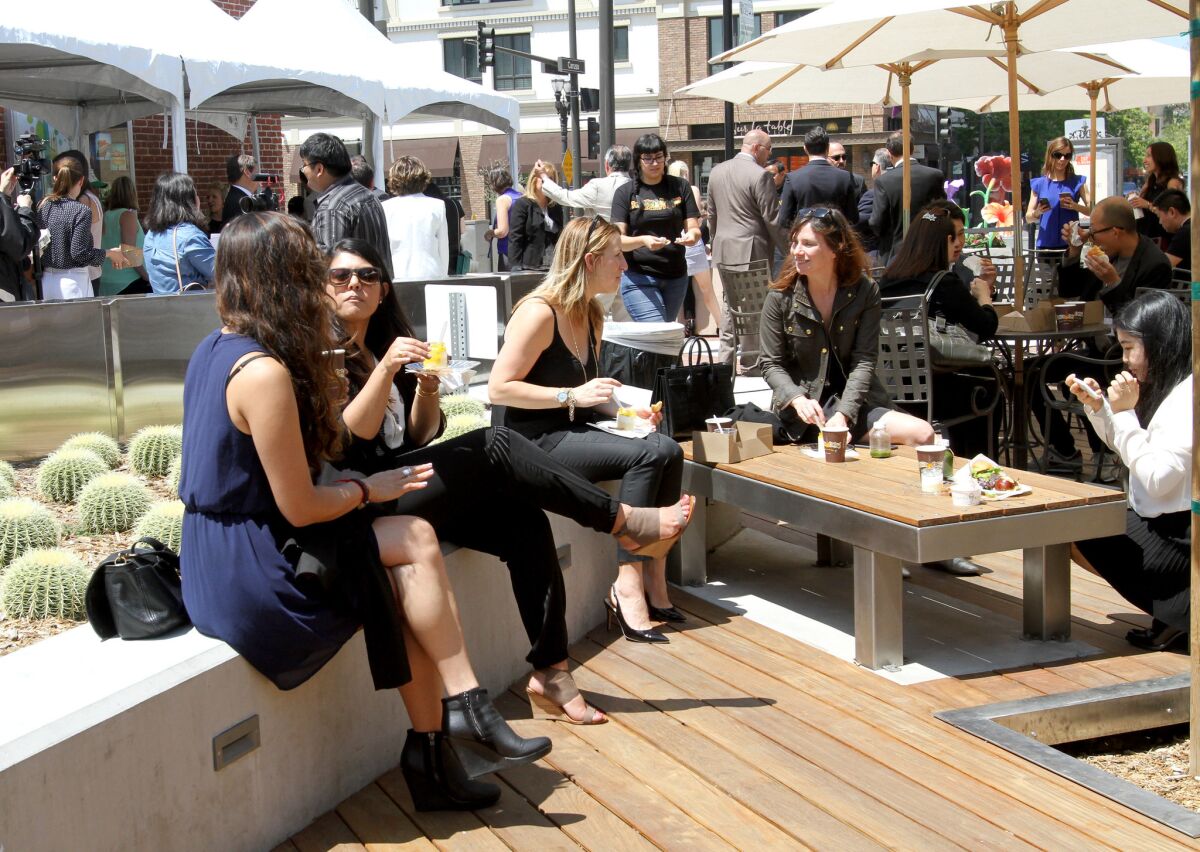 Attendees enjoy food from several restaurants at an event announcing five new eateries opening soon at Brand and Colorado in Glendale on Thursday, May 12, 2016.