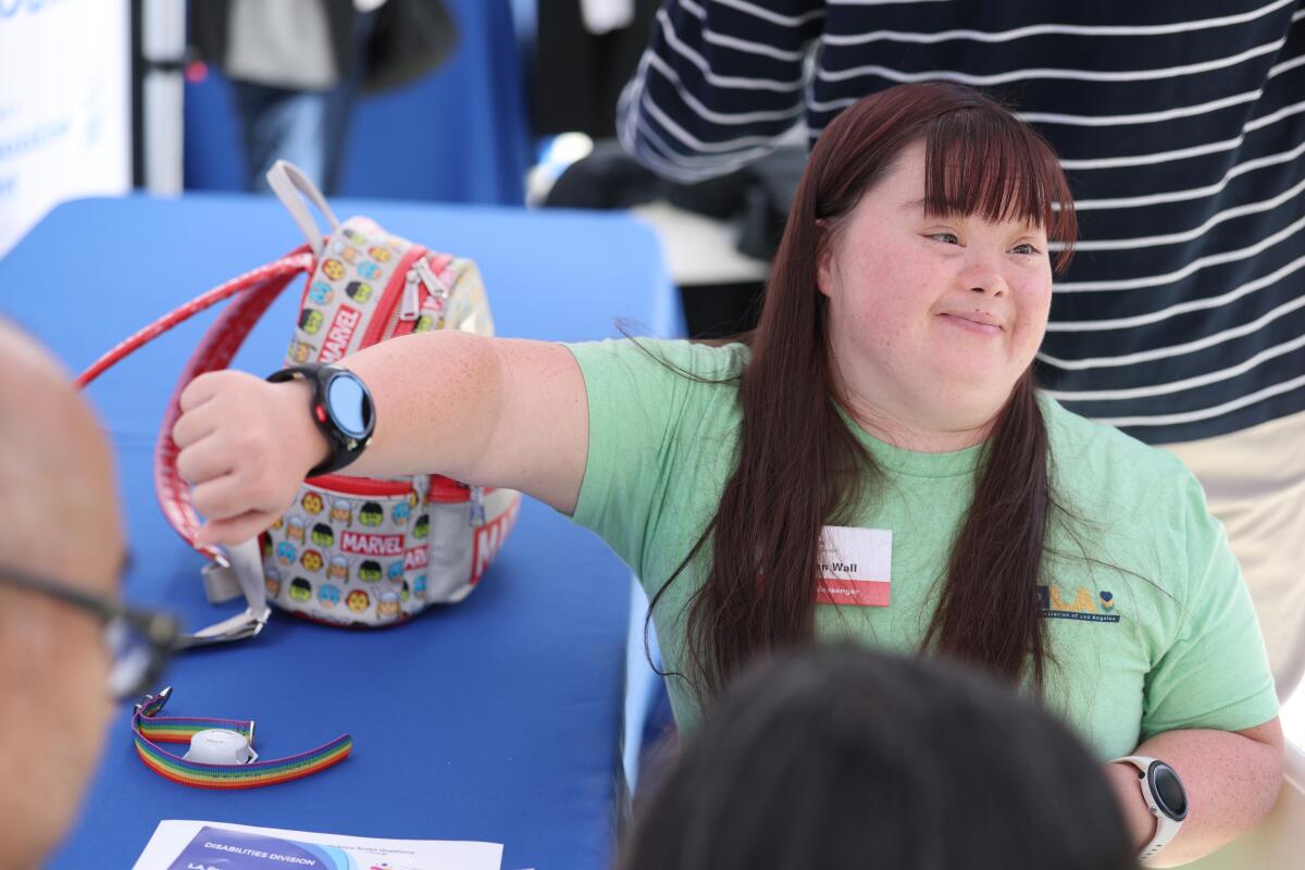 A community services analyst helps Jordan Wall set up her new GPS watch
