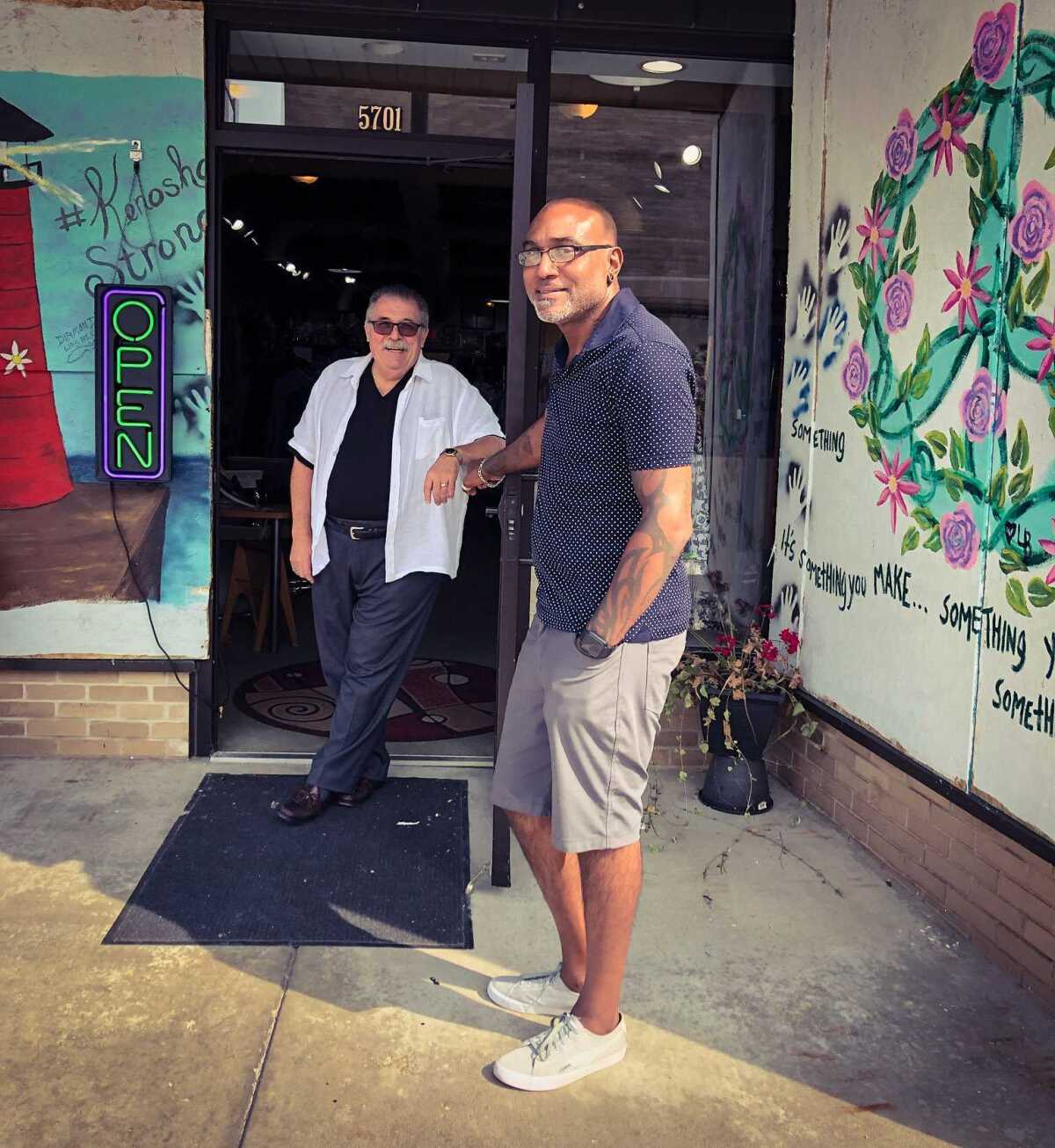 Shad DeLacy and Lewis Aceto stand in a storefront in Kenosha, Wis.