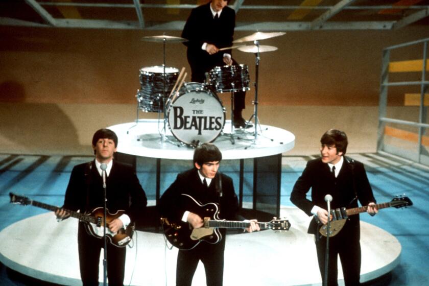 The four members of the Beatles perform on a TV soundstagein the 1964
