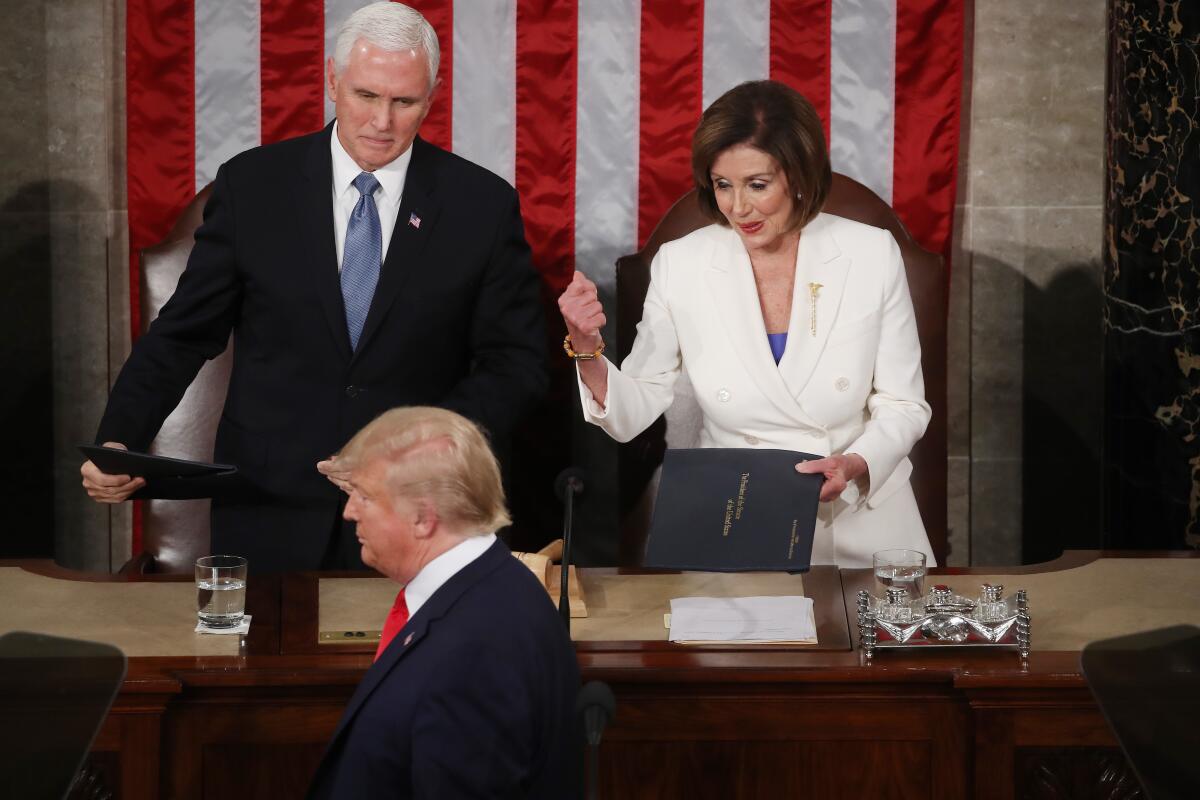 President Trump walks past Vice President Mike Pence and House Speaker Nancy Pelosi (D-Calif.) in 2020.