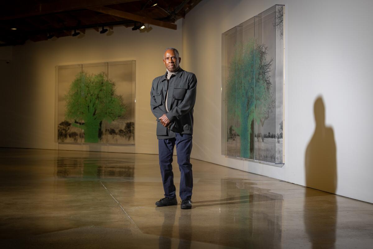 A man stands inside of an art gallery
