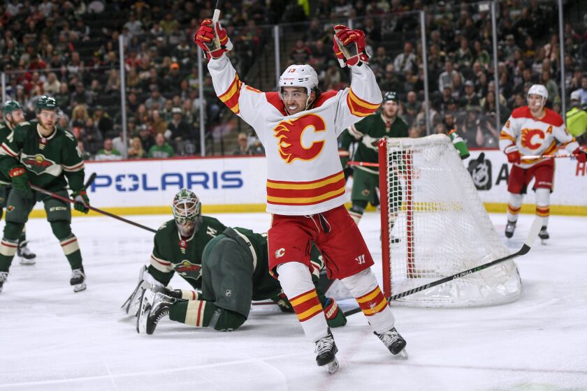 FILE - Calgary Flames left wing Johnny Gaudreau celebrates his goal on Minnesota Wild goalie Cam Talbot during the second period of an NHL hockey game April 28, 2022, in St. Paul, Minn. The Columbus Blue Jackets pulled off the improbable, landing the hottest free agent on the market in Gaudreau. He was lured to Columbus with a seven-year deal worth $9.75 million a season and the prospect of playing closer to his New Jersey home. (AP Photo/Craig Lassig, File)