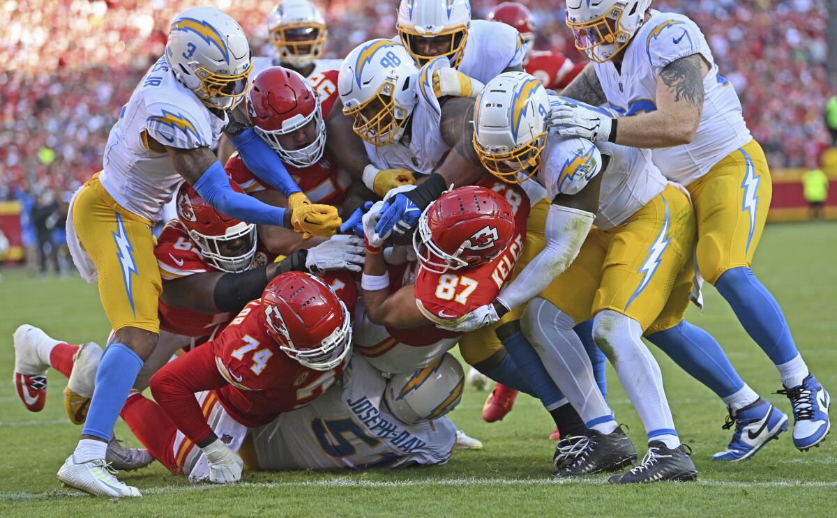 Kansas City Chiefs tight end Travis Kelce scores a touchdown during the first half against the Chargers at Arrowhead Stadium.