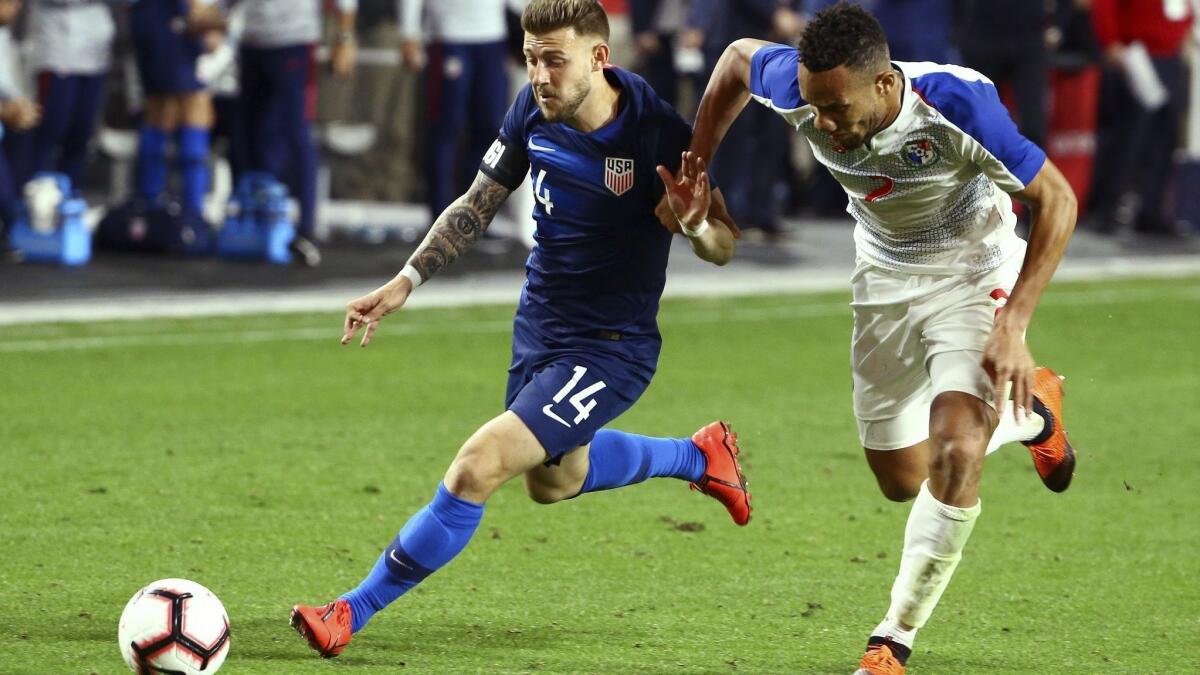 United States midfielder Paul Arriola (14) beats Panama defender Francisco Palacios to the ball during the second half of a men's international friendly soccer match on Sunday in Glendale, Ariz.