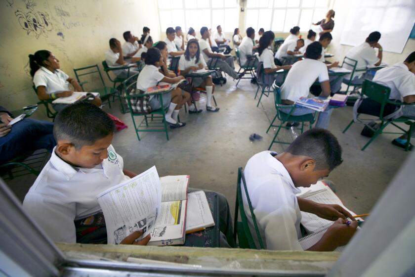 Students of the Primary School study in their classroom in Acapulco, Mexico, Tuesday, April 9, 2013. A plan to overhaul Mexico's public education system was ratified by 18 of the country's 31 states, allowing it to be enacted by President Enrique Pena Nieto. The law, which is backed by Pena Nieto and was approved by Congress in December 2012, calls for creation of a professional system for hiring, evaluating and promoting teachers without the "discretionary criteria" currently used in a system where teaching positions are often bought or inherited. (AP Photo/Marco Ugarte)