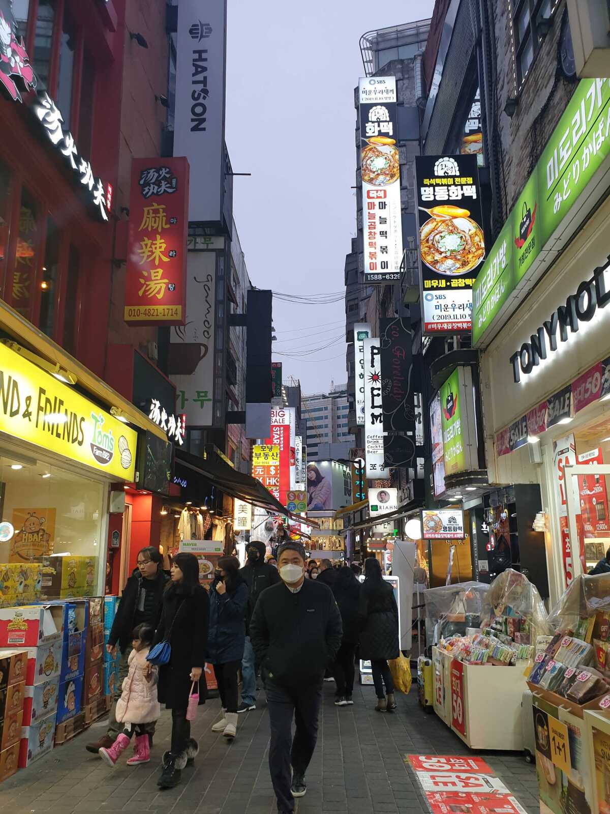 Tourists walk through a busy shopping street in the district of Myeongdong in central Seoul, a popular destination among Chinese visitors to the country.