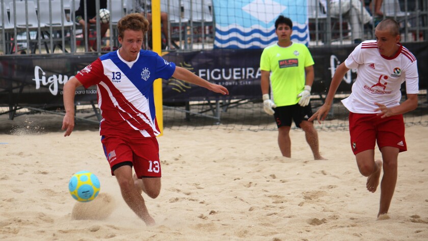 Legacy player Lars Ecklund of Mission Vista High (left) tries to control the ball in a match against the United Kingdom in Portugal.