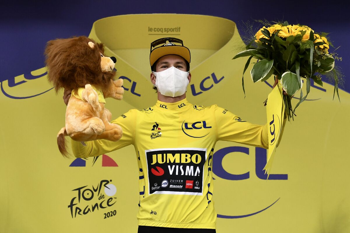 Primoz Roglic celebrates on the podium after completing the ninth stage of the Tour de France.