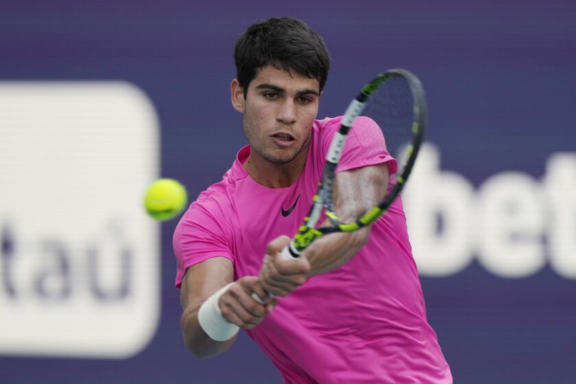 Carlos Alcaraz of Spain returns to Tommy Paul during the Miami Open tennis tournament, Tuesday, March 28, 2023, in Miami Gardens, Fla. (AP Photo/Marta Lavandier)