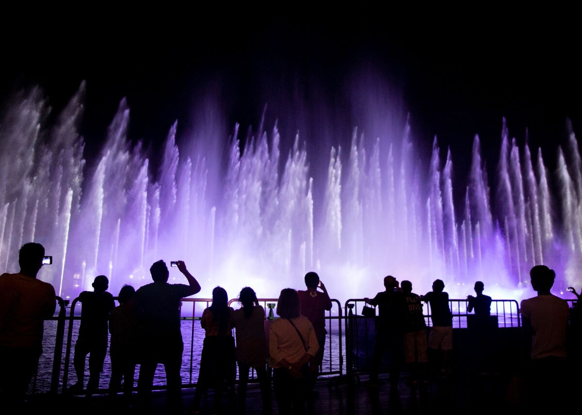 People watch a fountain show outside the Casino at Okada Manila in Entertainment City, in Paranaque, Philippines. The district has become the country’s premier casino destination, particularly for Chinese gamblers.