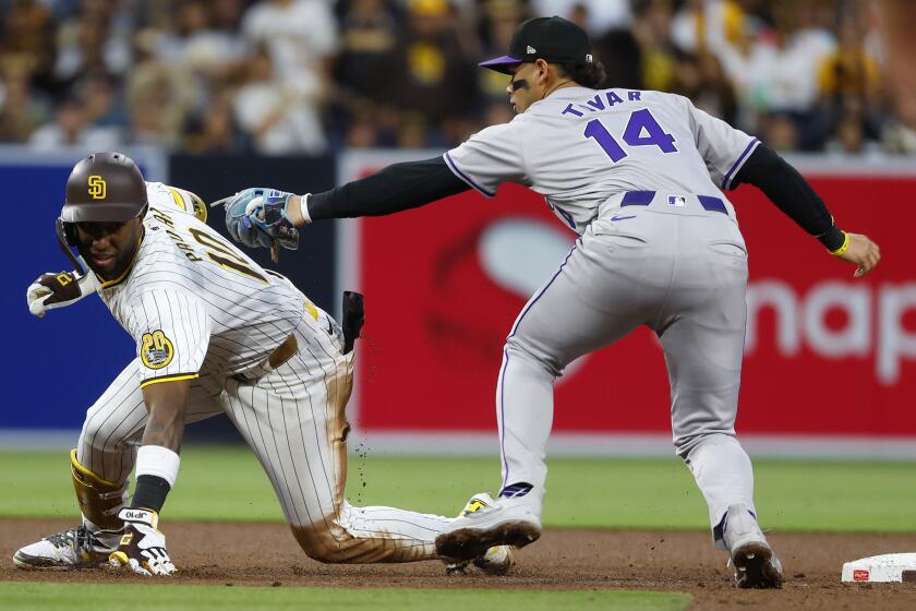 San Diego CA - May 14: San Diego Padres' Jurickson Profar is tagged out by Colorado Rockies' Ezequiel Tovar after over running second base in the fourth inning at Petco Park on Tuesday, May 14, 2024 in San Diego, CA. (K.C. Alfred / The San Diego Union-Tribune)