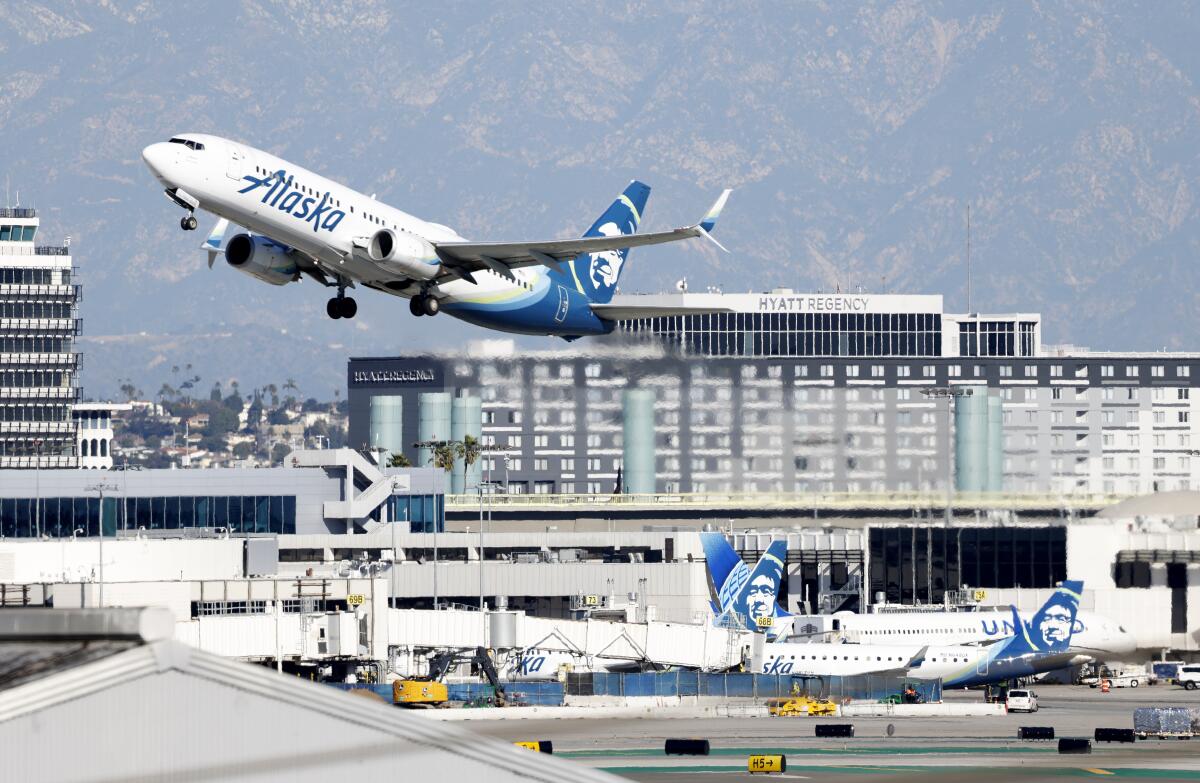 An Alaska Airlines flight takes off from Los Angeles International Airport.