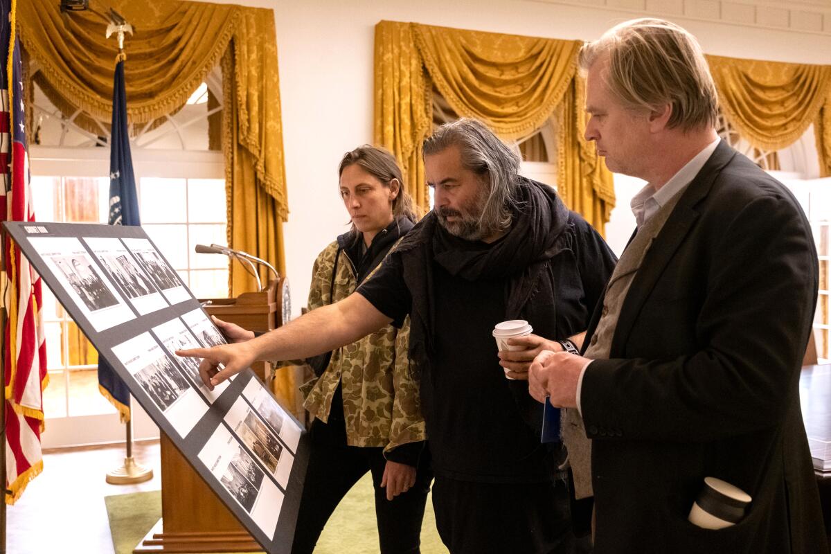 'Oppenheimer' filmmakers consult a board of photographs.