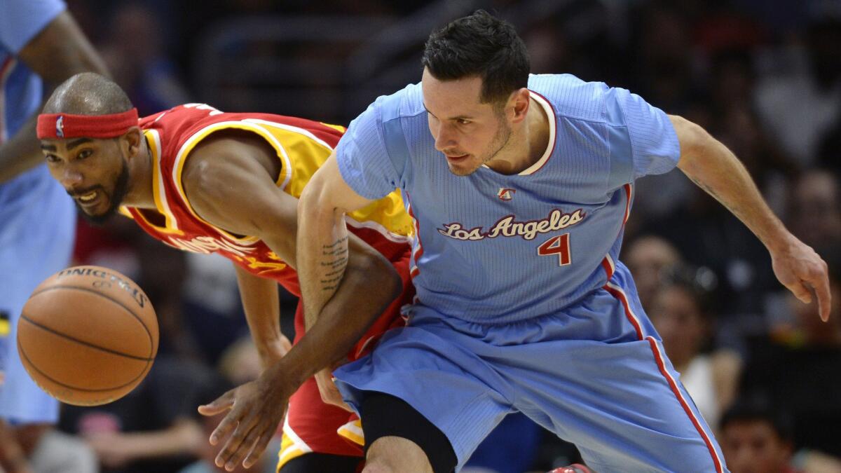 Clippers guard J.J. Reddick, right, and Houston Rockets guard Corey Brewer chase after a loose ball during the Rockets' 100-98 victory at Staples Center on March 15.