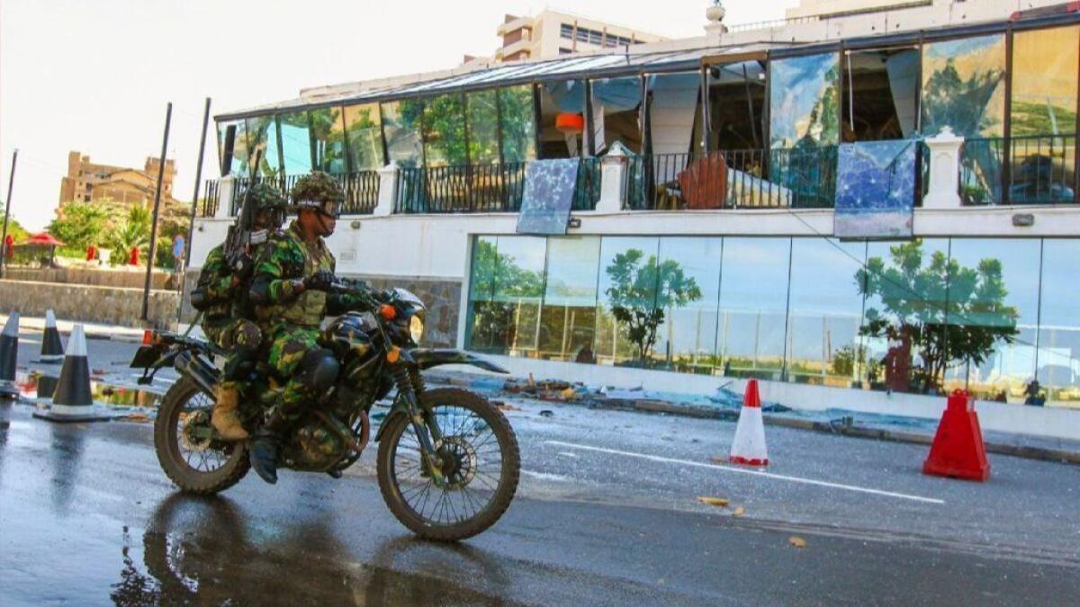 Sri Lankan soldiers drive past the Kingsbury Hotel, one of three upmarket hotels in the capital that were attacked by suicide bombers Sunday.