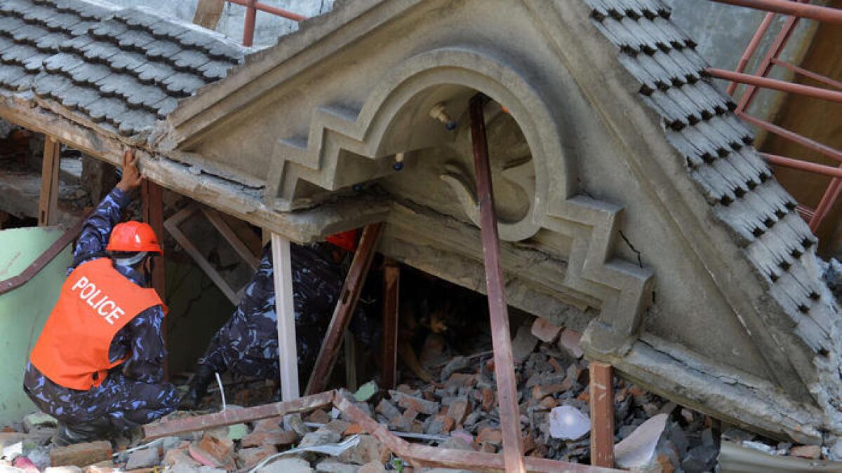 Un grupo de rescatistas revisa los escombros de un templo en Nepal, luego del tercer terremoto.