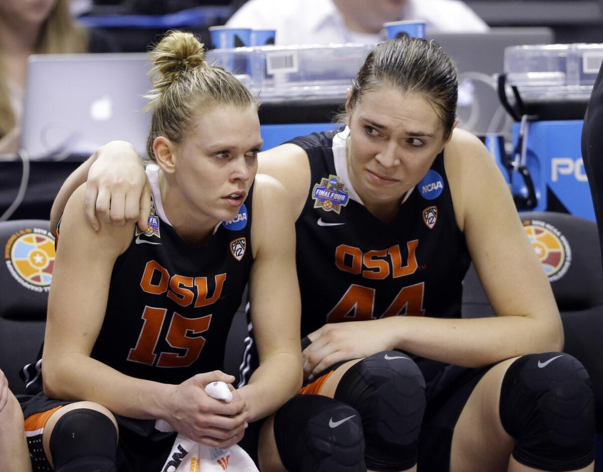Oregon State's Jamie Weisner (15) and Ruth Hamblin (44) watch the final minutes of their Final Four matchup against Connecticut.