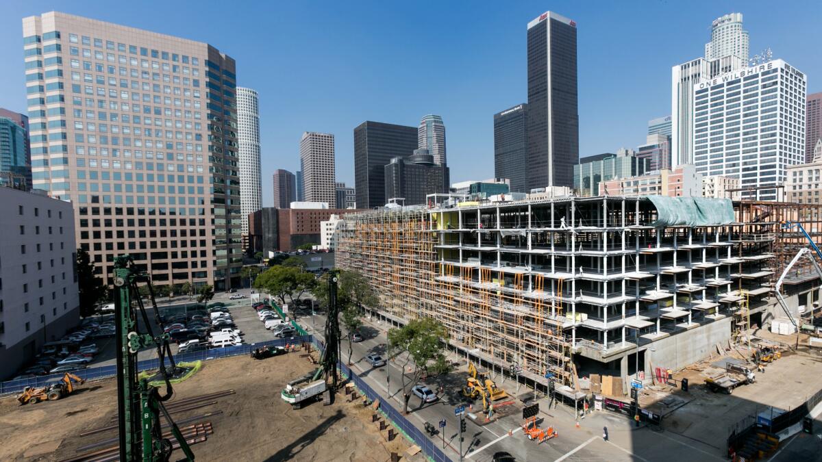 A 700-unit apartment complex rises in downtown Los Angeles in 2015. The proposed Neighborhood Integrity Initiative could put a moratorium on such projects.