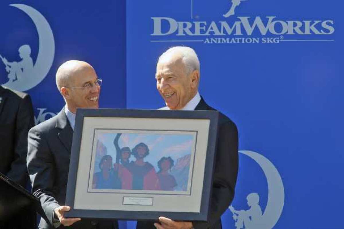 Israeli president Shimon Peres is given an original piece of artwork from the first Dreamworks animated feature film , "Prince of Egypt" by Jeffrey Katzenberg (left) at Dreamworks Animation SKG in Glendale on March 9, 2012. Peres earlier gave a speech to employees of Dreamworks Animation SKG.