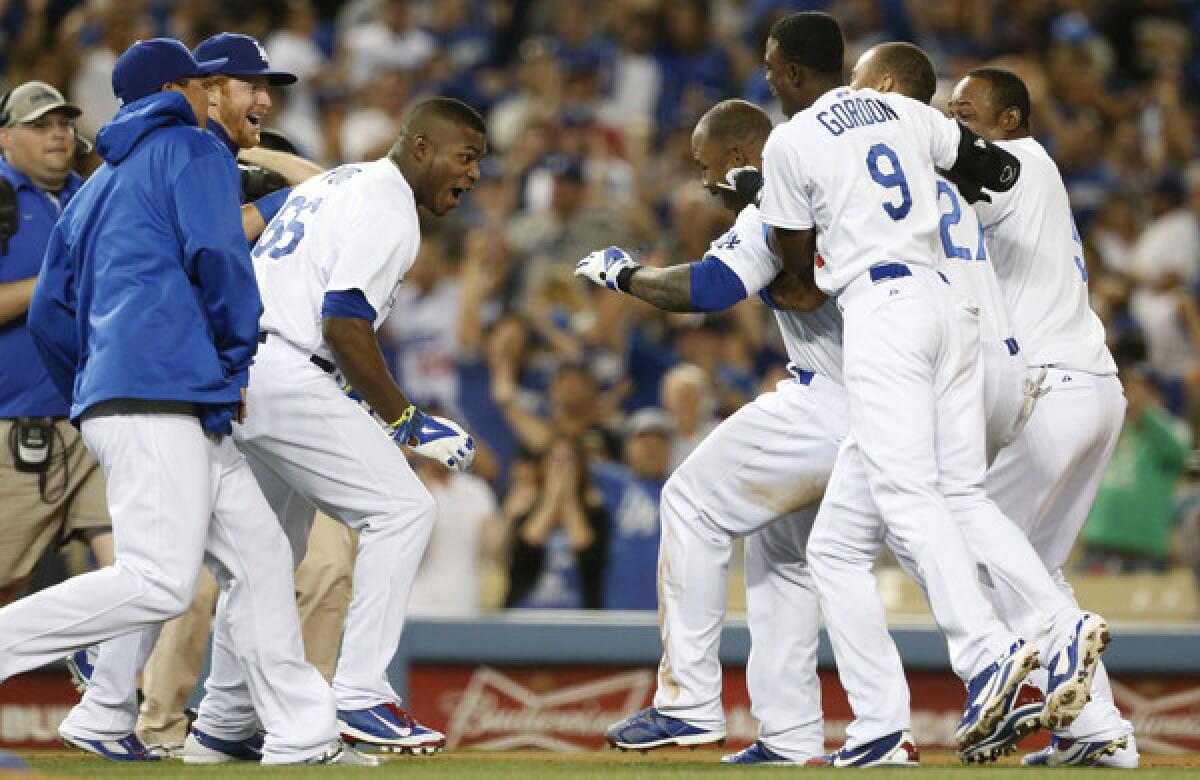 Carl Crawford, right center, celebrates with teammates after driving in the winning run in the 10th inning of the Dodgers' 3-2 win over the Detroit Tigers on Tuesday.